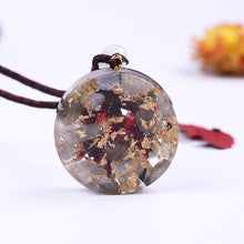 Load image into Gallery viewer, Rear view of an Orgonite pendant necklace with Garnet and Labradorite stones, showcasing gold foil shavings.