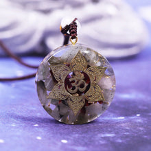 Load image into Gallery viewer, Orgonite pendant necklace with Garnet and Labradorite stones. Features a Lotus Flower and Aum copper energy patch in the center.