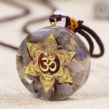 Load image into Gallery viewer, Orgonite pendant necklace with Garnet and Labradorite stones. Features a Lotus Flower and Aum copper energy patch in the center.