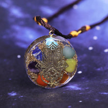 Load image into Gallery viewer, Orgonite pendant necklace with seven stones and a copper Hamsa energy patch.