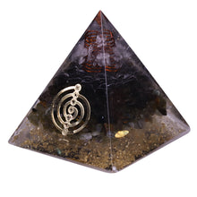 Load image into Gallery viewer, Orgonite pyramid with obsidian, labradorite and quartz crystals. Features a seven chakra copper energy patch and gold foil shavings.