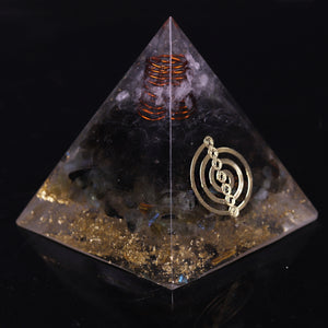 Orgonite pyramid with obsidian, labradorite and quartz crystals. Features a seven chakra copper energy patch and gold foil shavings.