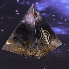 Load image into Gallery viewer, Orgonite pyramid with obsidian, labradorite and quartz crystals. Features a seven chakra copper energy patch and gold foil shavings.