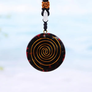 Rear view of red orgonite necklace with copper orgone energy accumulator.