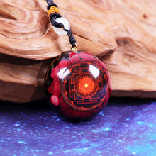 Load image into Gallery viewer, A red orgonite necklace with a Lotus flower design. Orgonite pendant contains Red coral, Red Sea Glass, Resin, Gold Foil