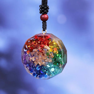 Rear view of an orgonite pendant necklace with seven stones, showing the reflective rainbow metal shavings.