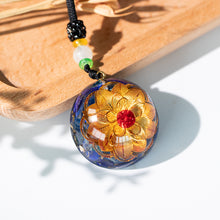 Load image into Gallery viewer, Golden lotus flower and lapis lazuli orgonite necklace from The Orgone Shop. 