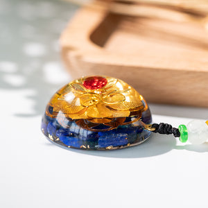 Golden lotus flower and lapis lazuli orgonite necklace from The Orgone Shop. 